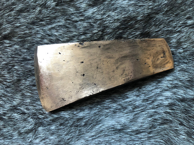 Early Bronze Age axe head replica. Life size.